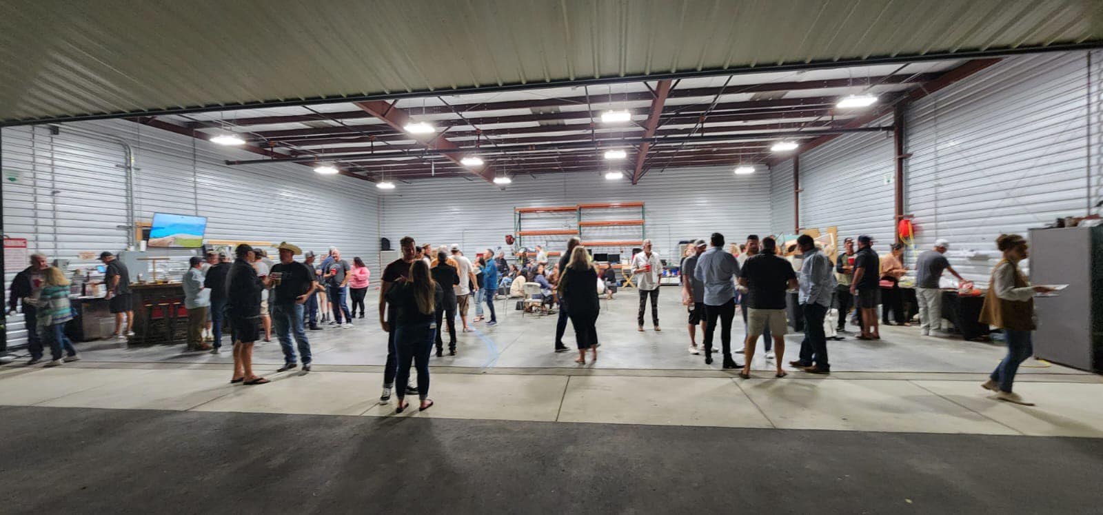 Hangar event with crowd of people gathered inside